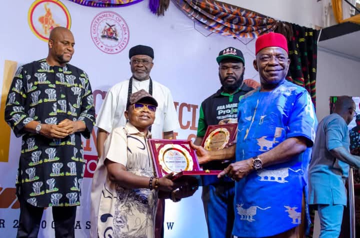Gov Alex Otti of Abia (right) handing over an Award to Nollywood Artistes, Mr Chinedu Ikedieze (Aki) (left), while others watches, during the formal flag-off of the Aba Made Film Project, titled “The Chronicles of Enyimba City" at Aba, Abia State